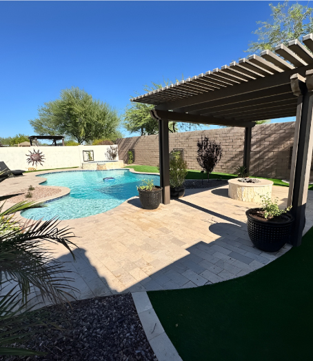 freeform pool with outdoor fireplace and pergola